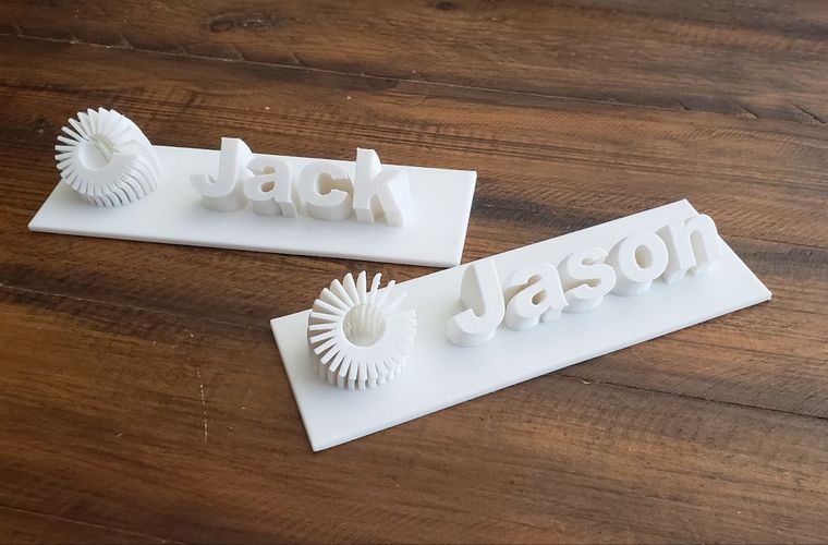 Two 3D-printed desk name placards reading Jack and Jason