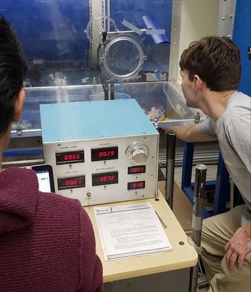 Team members running the wind tunnel control panel