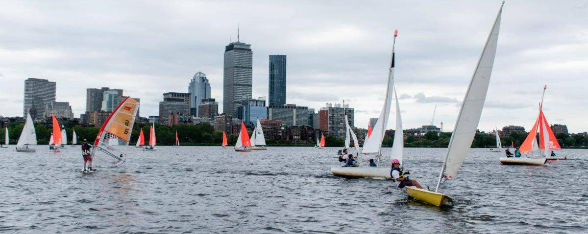 Fleet of dinghies with colorful sails racing on the Charles
