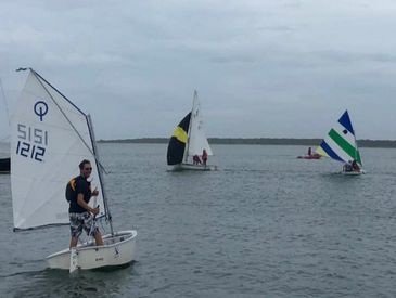 Opti dinghies sailing in a junior program